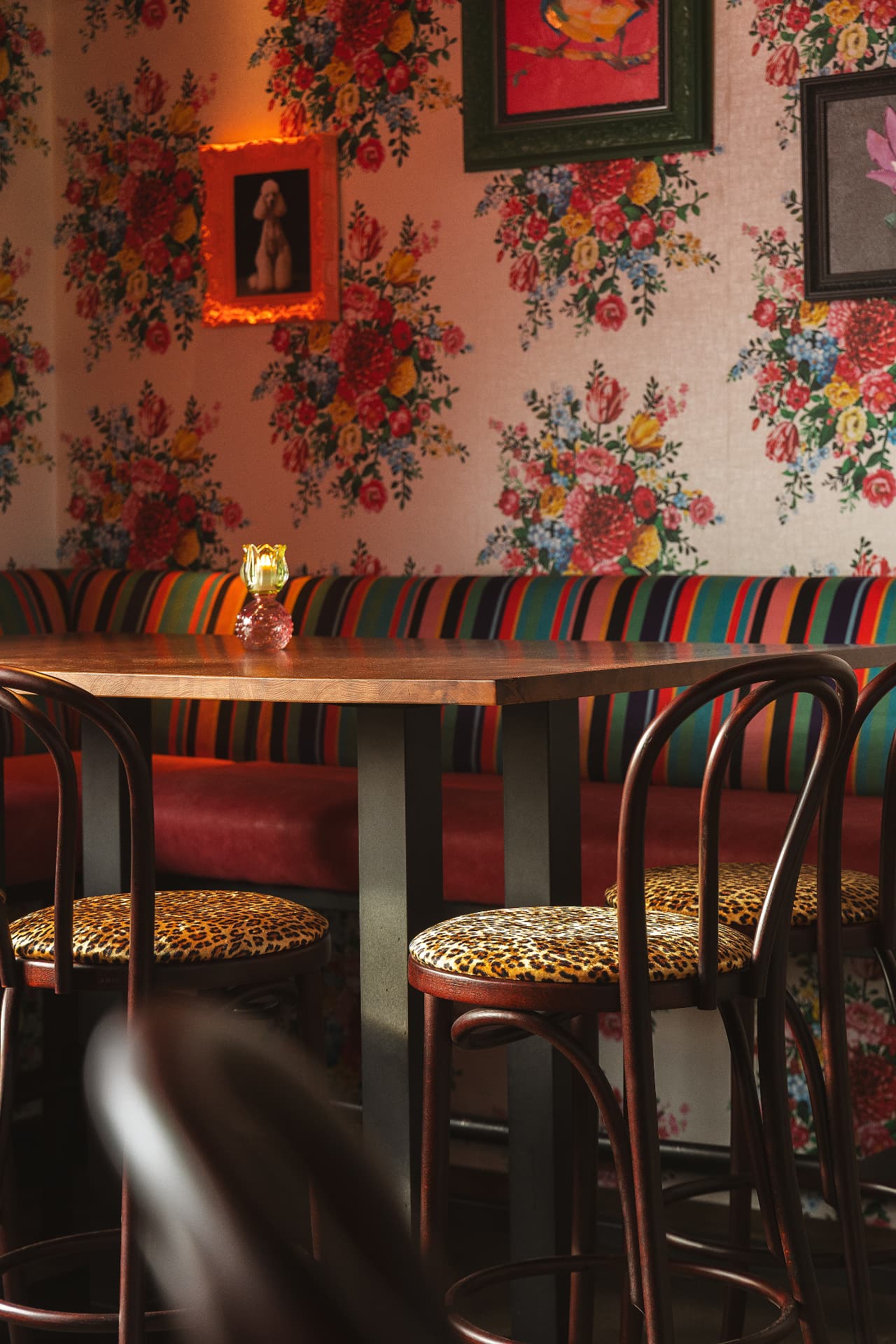 De bar van Nonna's Cucina met bloemig behang en gekleurde kussens